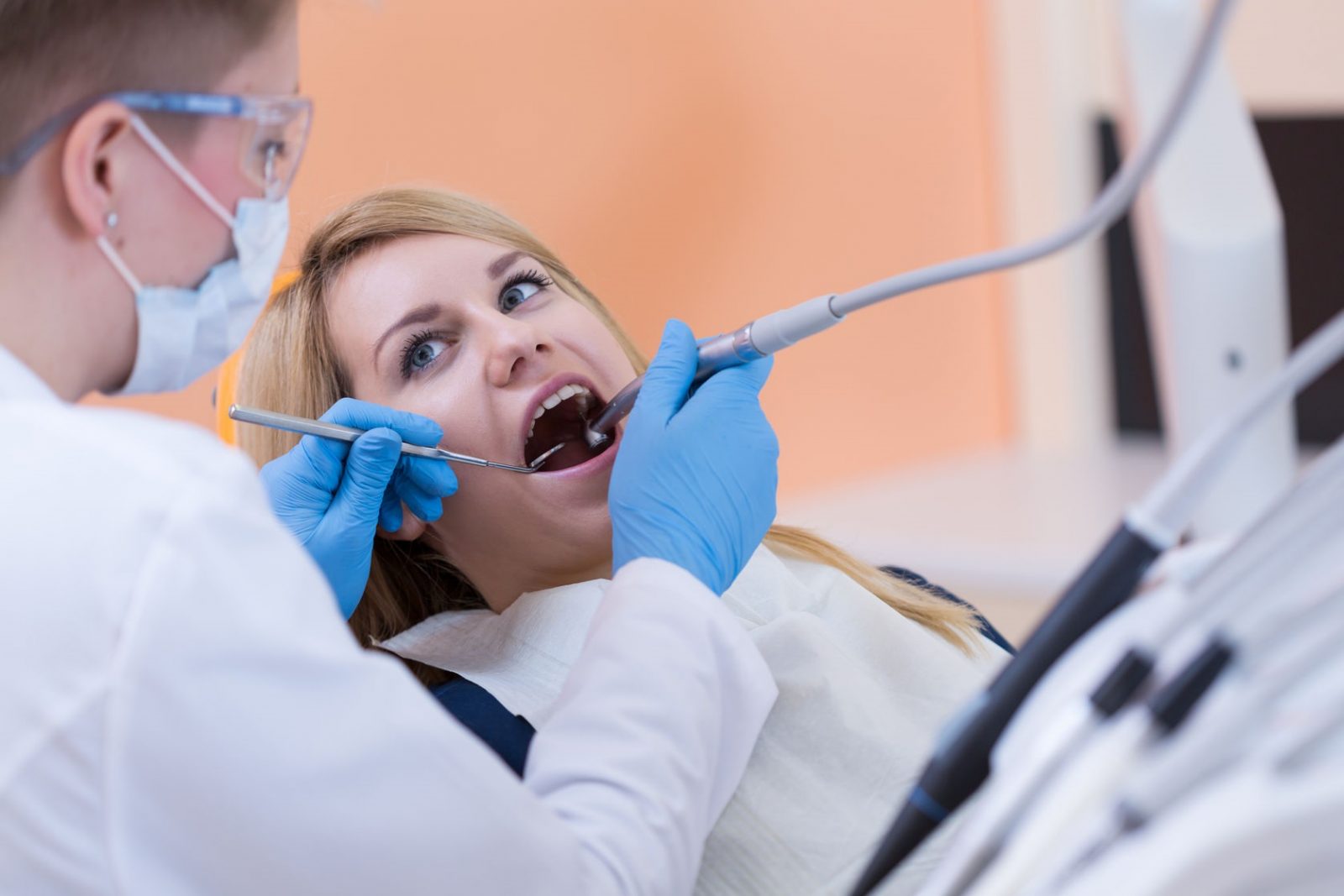 35650508 - dentist drilling a tooth of young woman